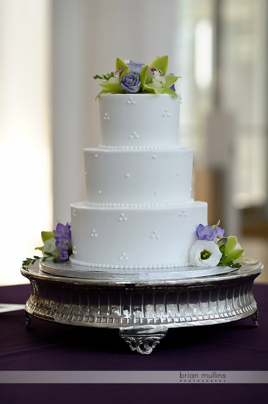 white wedding cake with purple flowers