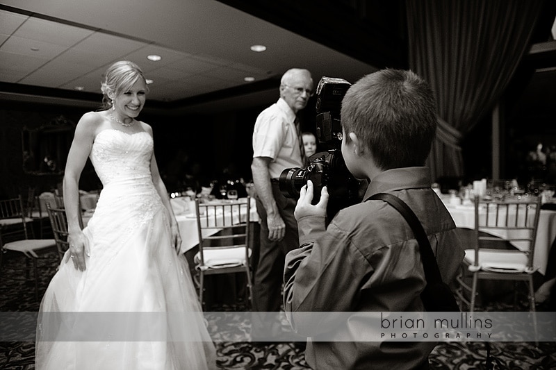 wedding guest with wedding photographers camera