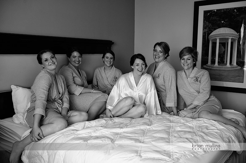 bride and bridesmaids on bed