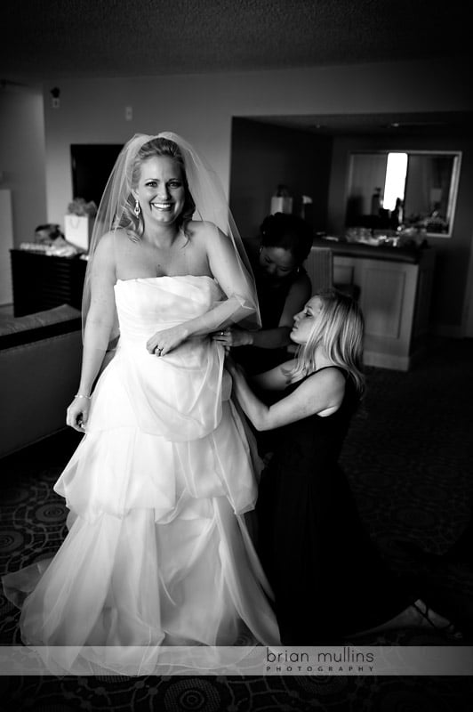 bridesmaids helping bride