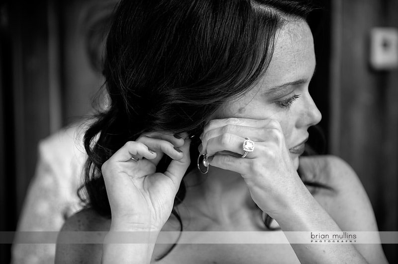 bride putting on earrings