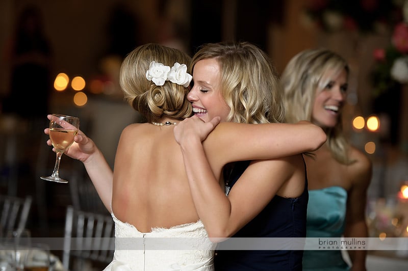 bride hugging friends at reception