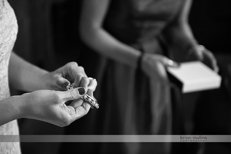 bride putting on jewelry