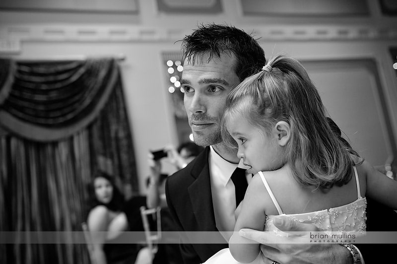 groom watching father daughter dance