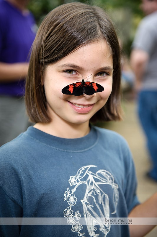 butterfly landing on girls face