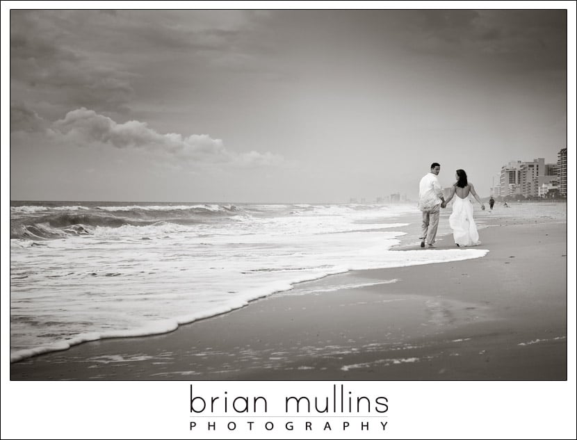 bride and groom walk along Myrtle Beach