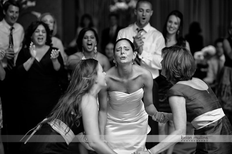 bride singing witih bridesmaids