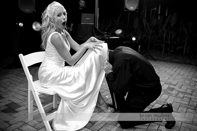 grooms head under brides dress