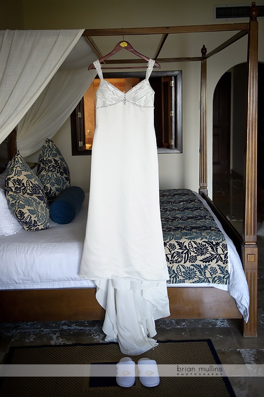 wedding dress hanging on four poster bed