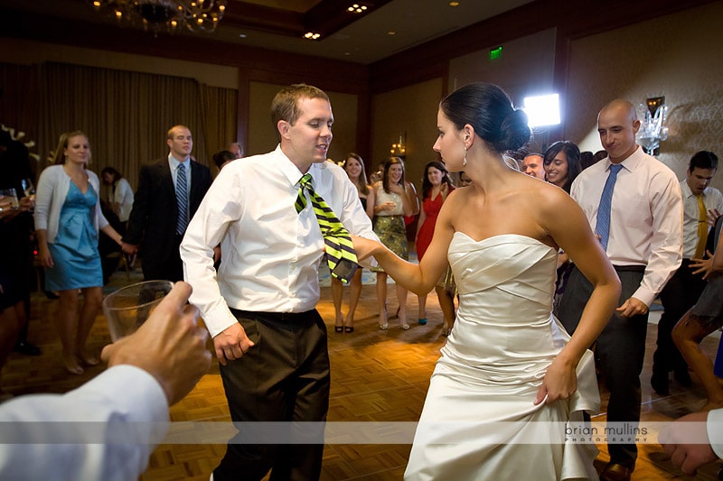 bride pulling grooms tie