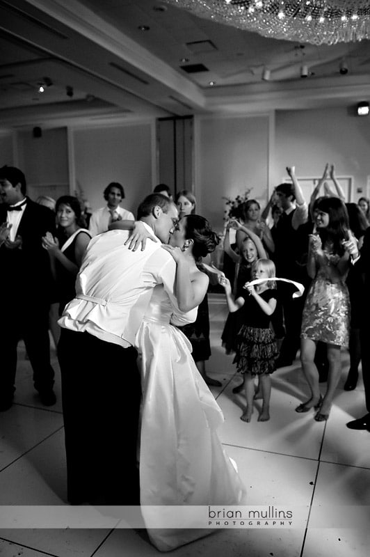 bride and groom kissing at wedding reception