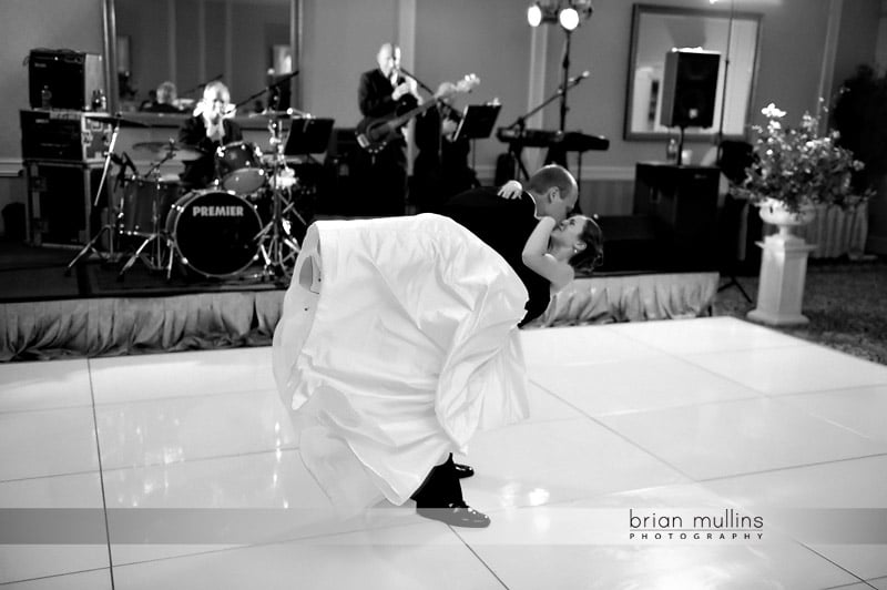 bride and groom kissing at wedding reception