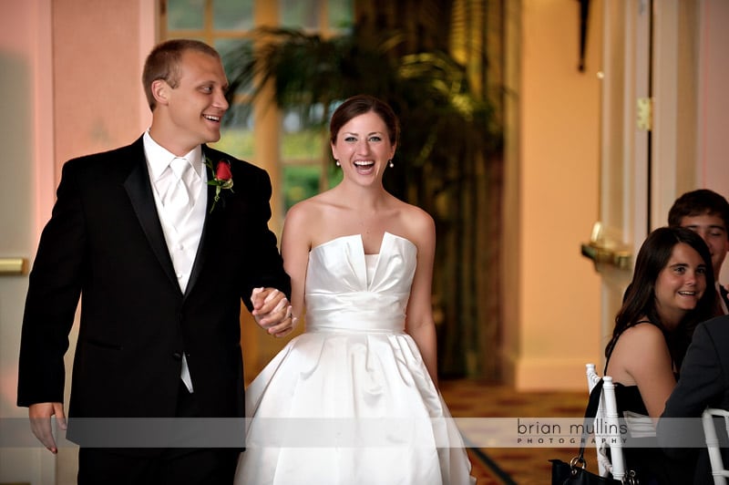 bride and groom walking into wedding reception