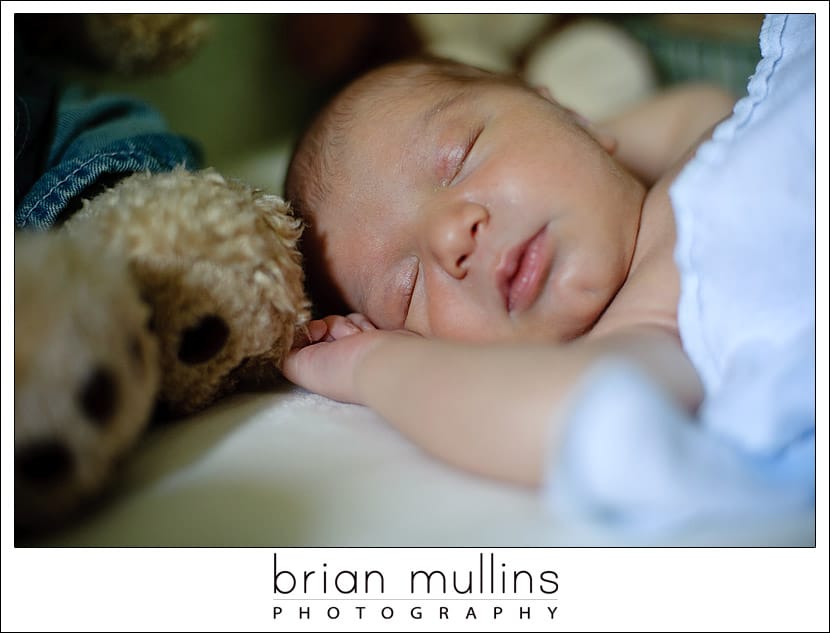 Newborn in crib with ambient light