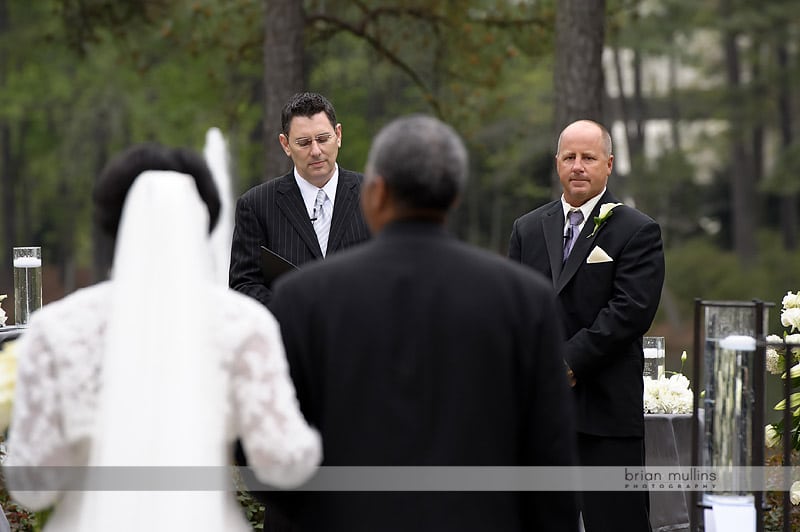 groom sees bride walkingn down the aisle