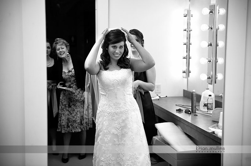 bride putting on veil