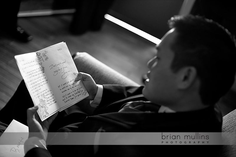 groom reading card from bride on wedding day