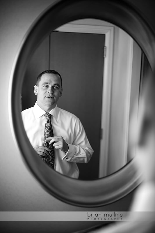 groom putting on his tie