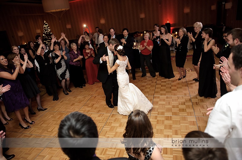 bride and groom dancing in circle of friends