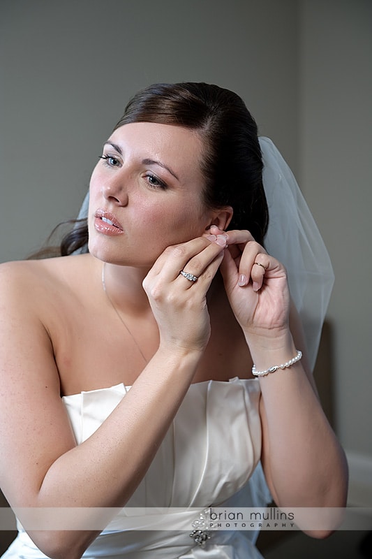 bride putting on earring