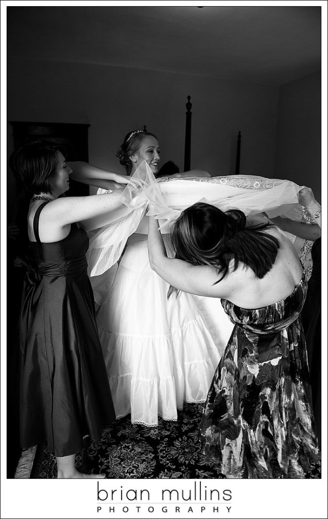 Bride putting on wedding dress - Raleigh Wedding Photographer