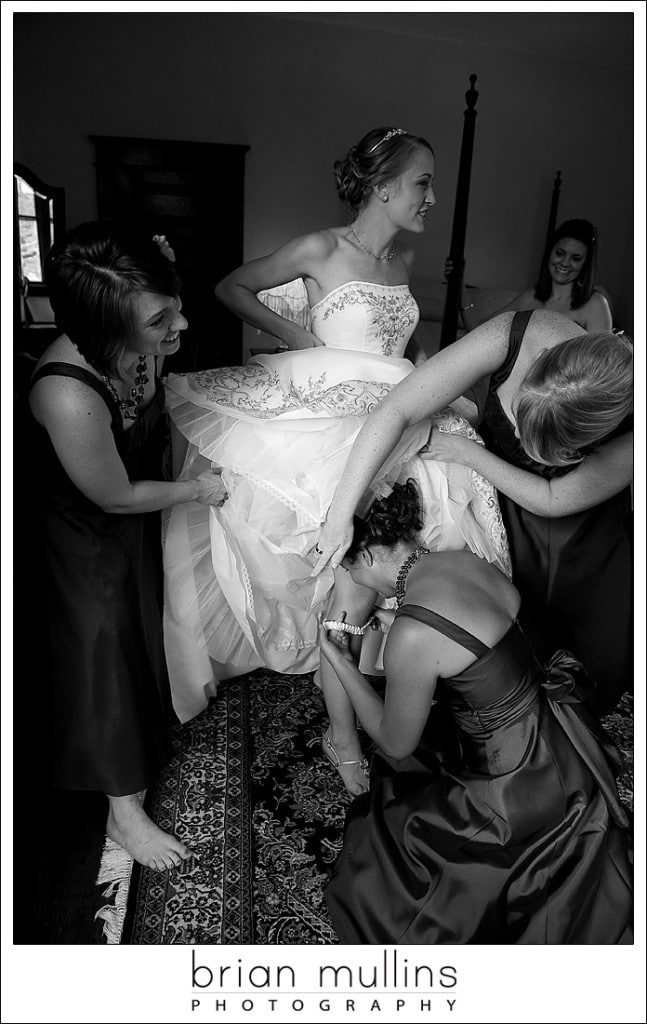 bride putting on garter - Raleigh, NC wedding photographer