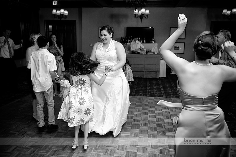 bride dancing with kids at wedding reception