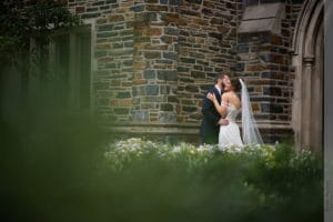bride and groom posing outside their duke chapel wedding